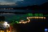 7月3日，三都渔村旁的江面上船队船灯亮起（无人机照片）。
