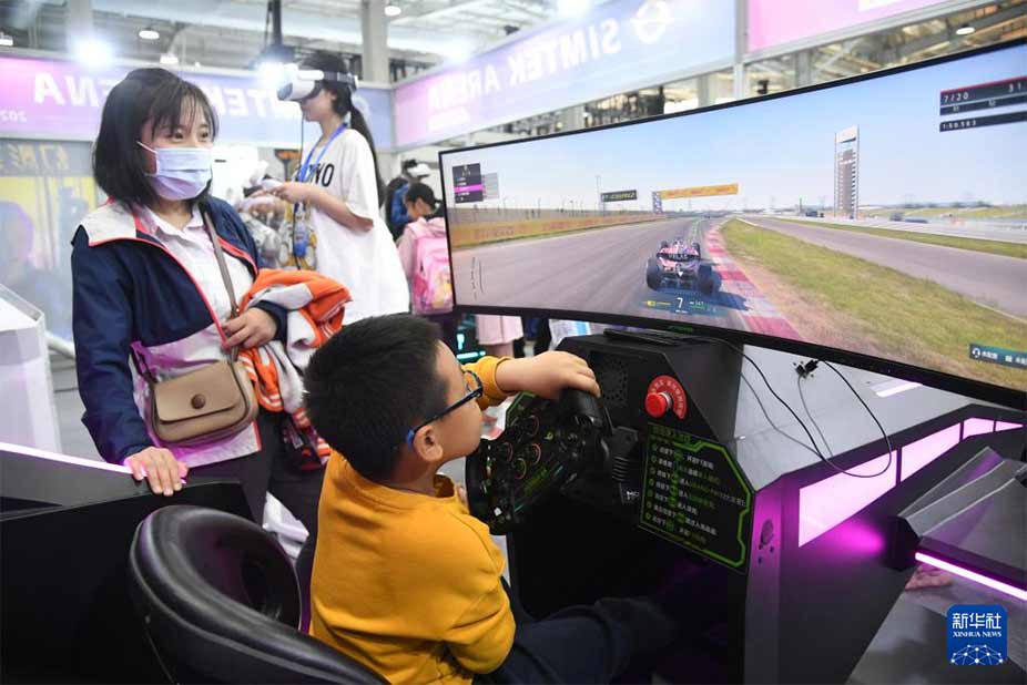 4月27日，小朋友在北京科幻嘉年华现场体验一款赛车体感游戏。新华社记者 任超 摄